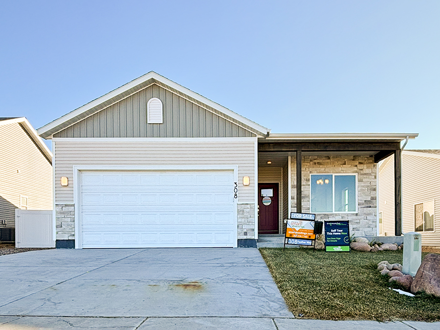 New Smart Dwellings Grey and White  home with Stone Accents, a gable roof and 2-car garage